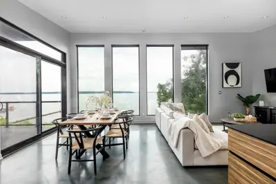 a living room with a table and a couch at Casa Luna Chic Lakehouse BBQ Game Room LakeViews in Orillia