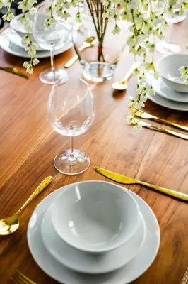 a wooden table with white plates and glasses on it at Casa Luna Chic Lakehouse BBQ Game Room LakeViews in Orillia