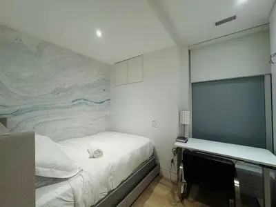 a bedroom with a bed and a wall mural at Camden Haus Loft in Toronto