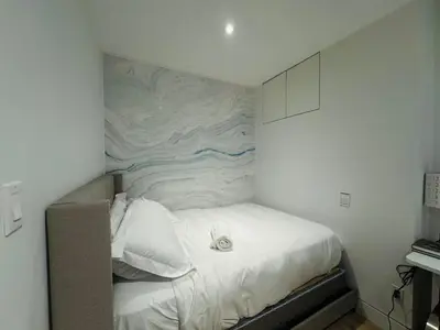 a bedroom with a bed with a mural on the wall at Camden Haus Loft in Toronto