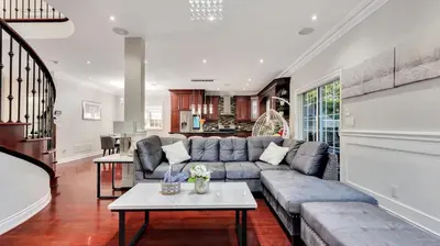 a living room with a couch and a table at Cozy Luxurious Villa in Toronto in Toronto