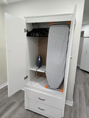a white closet with white drawers at Charming Suite in Cambridge