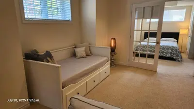 a small bedroom with a bed and a mirror at Spacious 2 BR, 3 beds, sleeps 6, kitchen, laundry in Richmond Hill