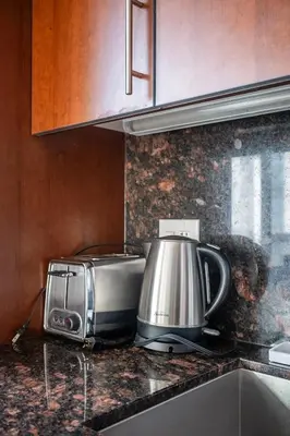 a kitchen counter with a coffee maker and a toaster at Cozy 1 BR & Den Condo in North York Free Parking in Toronto
