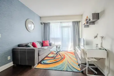 a living room with a couch and a table at Modern 2Bd 2Ba Skyscraper Free parking in Toronto