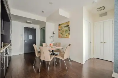 a kitchen and dining room with a table and chairs at Modern 2Bd 2Ba Skyscraper Free parking in Toronto
