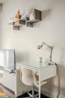 a white desk with a lamp and a chair at Modern 2Bd 2Ba Skyscraper Free parking in Toronto