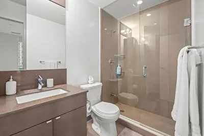 a bathroom with a toilet sink and a shower at luminous 2-Bedroom Apartment with Balcony in Toronto
