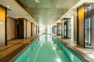 a swimming pool in a building with an empty at luminous 2-Bedroom Apartment with Balcony in Toronto