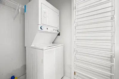 a white washer and dryer in a small kitchen at Modern New 2Bd 2Ba &Den Condo with Balcony in Toronto