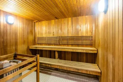 a sauna with wooden walls and benches and lights at Modern New 2Bd 2Ba &Den Condo with Balcony in Toronto