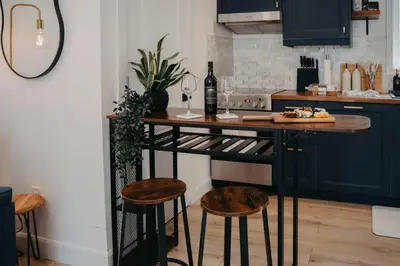 a kitchen with a bar with a bottle of wine at The Hideout in Barrie