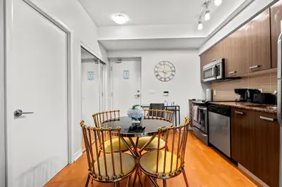 a kitchen with a table and chairs in a room at 1BR High Floor View Downtown Toronto in Toronto