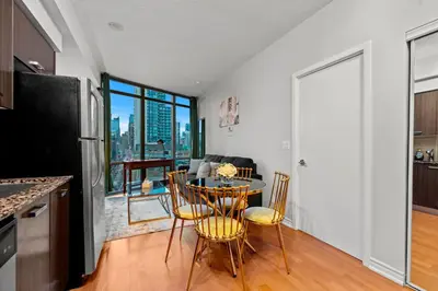 a kitchen and dining room with a table and chairs at 1BR High Floor View Downtown Toronto in Toronto