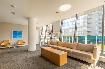 a living room with a couch and some windows at 1BR High Floor View Downtown Toronto in Toronto