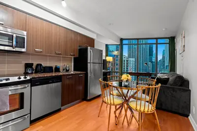 a kitchen with a table and chairs in a kitchen at 1BR High Floor View Downtown Toronto in Toronto