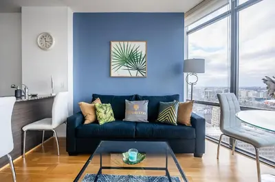 a blue living room with a couch and a table at 1BR High Floor View Downtown Toronto in Toronto