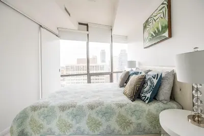a bedroom with a bed with a view of a city at 1BR High Floor View Downtown Toronto in Toronto