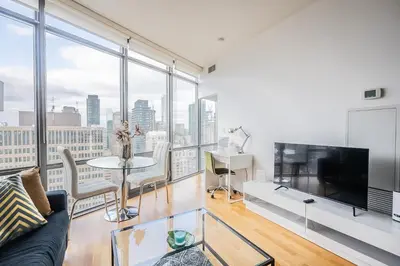 a living room with a couch and a tv at 1BR High Floor View Downtown Toronto in Toronto