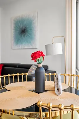 a table with a vase with a red flower on it at Magnificent 1 Bd High floor view Downtown Toronto in Toronto
