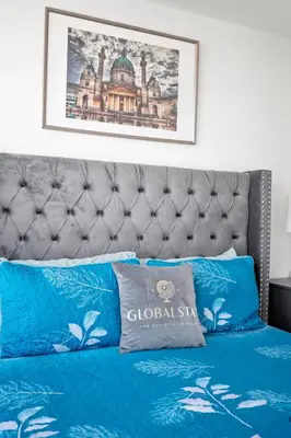 a bed with blue pillows on top of it at Magnificent 1 Bd High floor view Downtown Toronto in Toronto