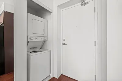 a door leading into a room with a tv at Magnificent 1 Bd High floor view Downtown Toronto in Toronto