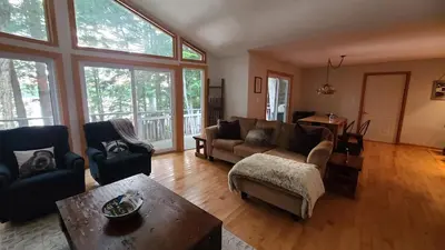 a living room with a couch and a table at Sunset Heaven 3 Bedroom Lakefront Retreat in Bracebridge