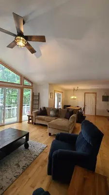a living room with a couch and a ceiling fan at Sunset Heaven 3 Bedroom Lakefront Retreat in Bracebridge