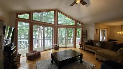 a living room with a couch and a table at Sunset Heaven 3 Bedroom Lakefront Retreat in Bracebridge