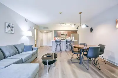 a living room with a couch and a table at 2BR King Suite Pool Sauna Heated Pool in Shanty Bay