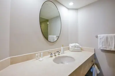 a bathroom with a sink and a mirror at The King Studio Sauna Haven in Shanty Bay