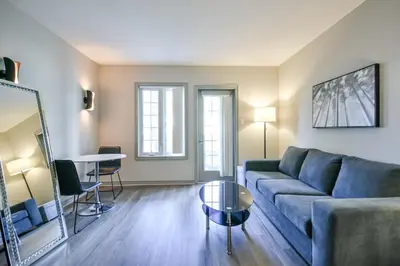 a living room with a couch and a table at The King Studio Sauna Haven in Shanty Bay