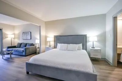 a bedroom with a large bed and a couch at The King Studio Sauna Haven in Shanty Bay