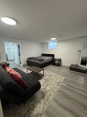 a living room with two beds and a couch at Studio Basement Apartment in Kitchener
