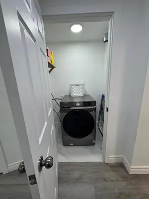 a door to a room with a microwave in a room at Studio Basement Apartment in Kitchener