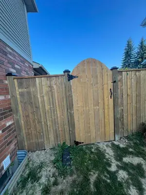a wooden fence in front of a house at Studio Basement Apartment in Kitchener