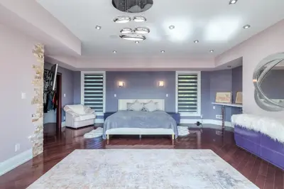 a bedroom with a king sized bed and purple walls at Private Oasis in King City in King City