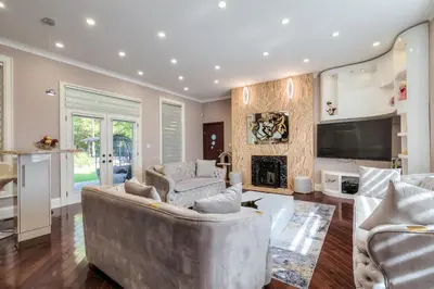 a living room with two couches and a fireplace at Private Oasis in King City in King City