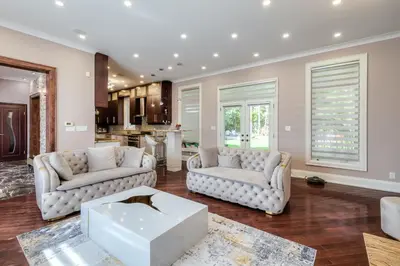 a living room with two couches and a kitchen at Private Oasis in King City in King City
