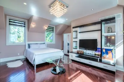 a bedroom with a bed and a flat screen tv at Private Oasis in King City in King City