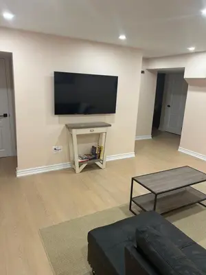 a living room with a flat screen tv on a wall at North Brampton Getaway in Brampton