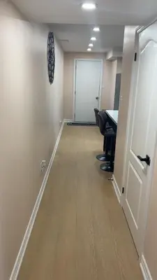 an office hallway with a table and chairs and a door at North Brampton Getaway in Brampton