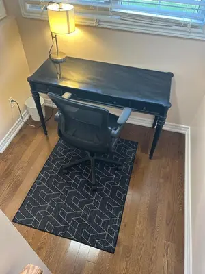 a black desk with a chair and a lamp at North Brampton Getaway in Brampton