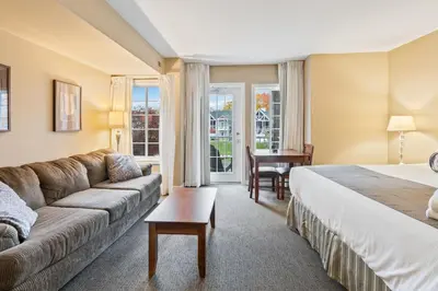 a hotel room with a bed and a couch at Gym,Pool,PetFriendly,KingBeds in Shanty Bay