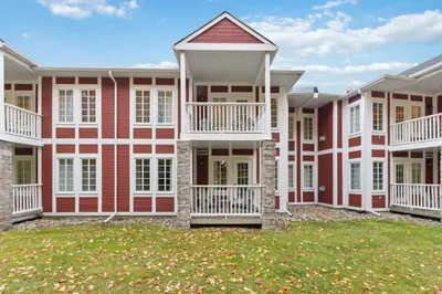 a large red and white building with a yard at Gym,Pool,PetFriendly,KingBeds in Shanty Bay