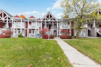 a large red and white house with a yard at Gym,Pool,PetFriendly,KingBeds in Shanty Bay