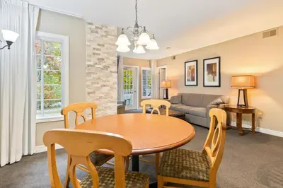 a living room with a table and chairs and a couch at Gym,Pool,PetFriendly,KingBeds in Shanty Bay