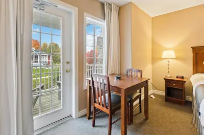 a room with a desk and a bed and a window at Gym,Pool,PetFriendly,KingBeds in Shanty Bay