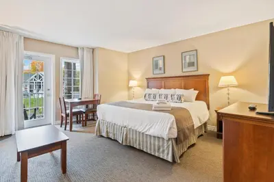 a hotel room with a bed and a desk and a television at Gym,Pool,PetFriendly,KingBeds in Shanty Bay