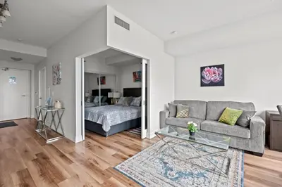 a living room with a couch and a bed at Attractive 1 Bedroom High Floor with Skyline View in Toronto